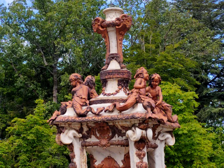 Detalle de las esculturas que decoran la fuente. En la parte superior aparecen niños tritones jugando y adornos de conchas y guirnaldas.